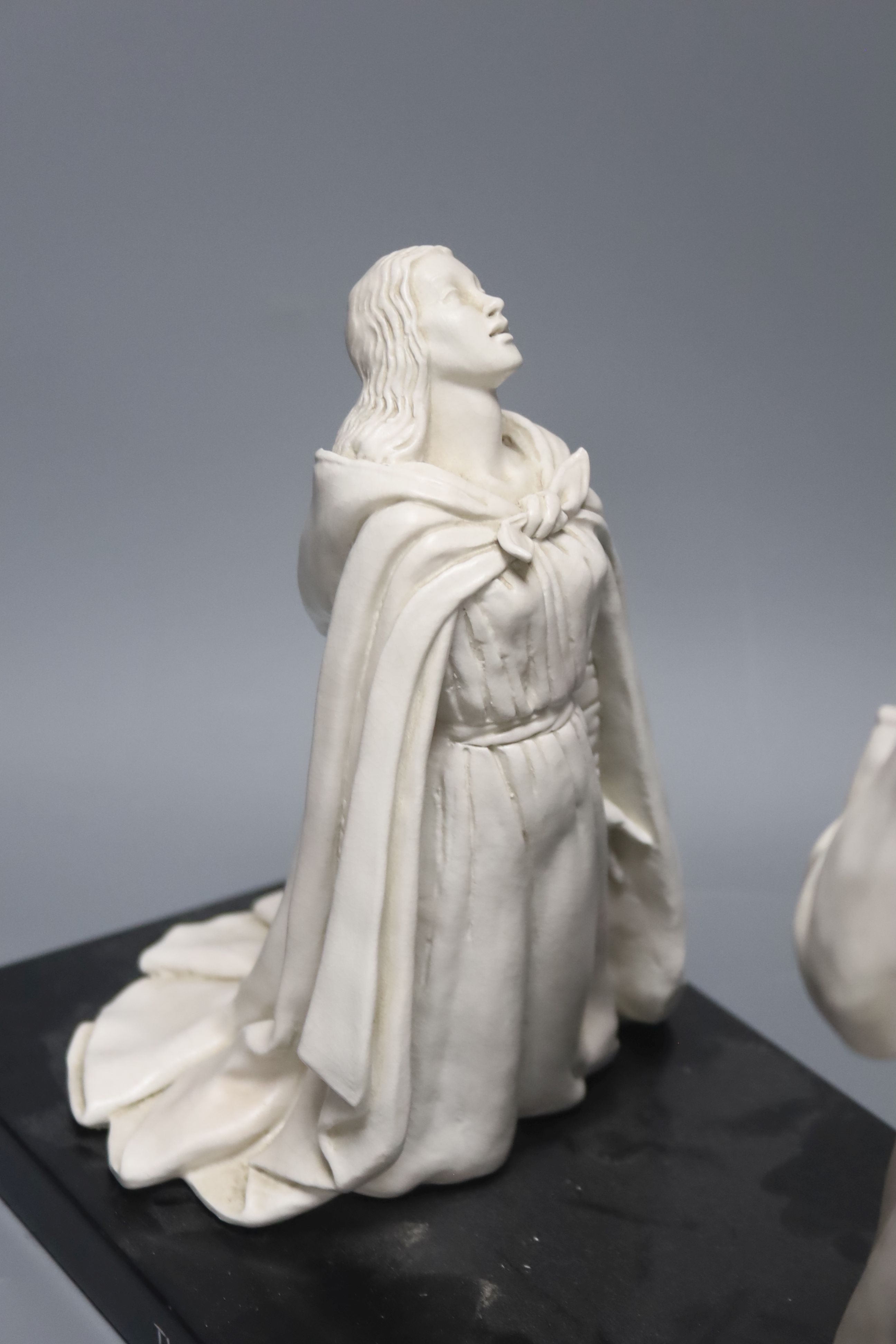 B.Henry 1956. A ceramic group 'The Annunciation', on stand, length 40cm